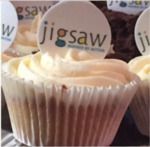 Birthday cup cake with Jigsaw logo on top